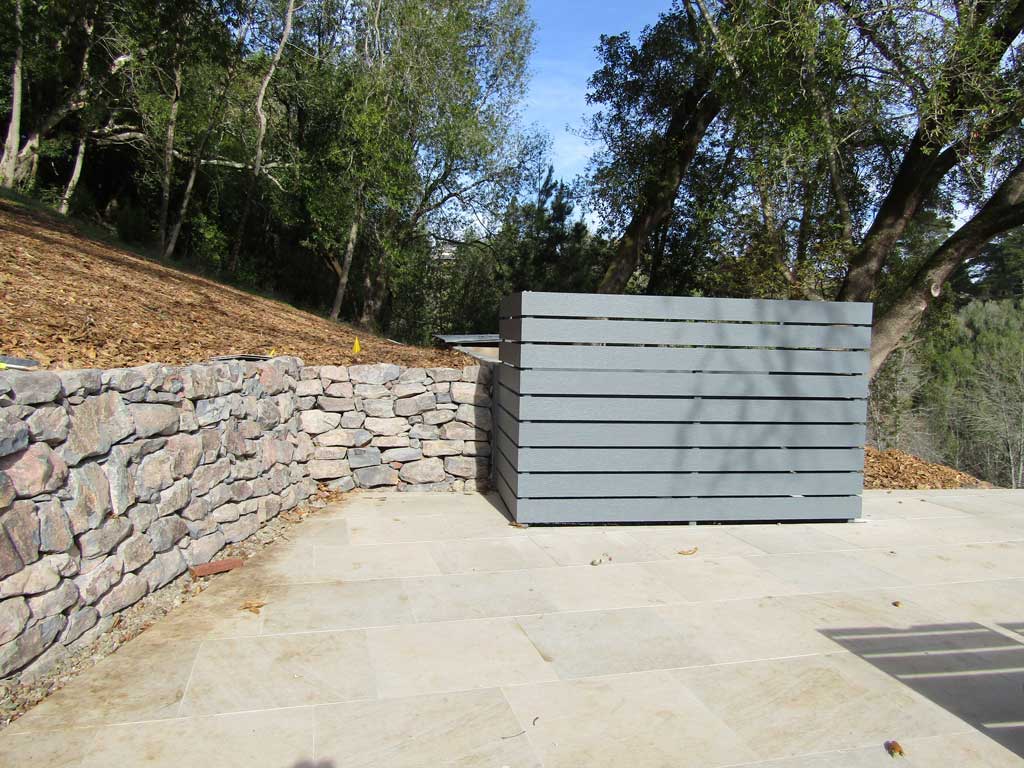 Dry-stacked stone wall in an established landscape