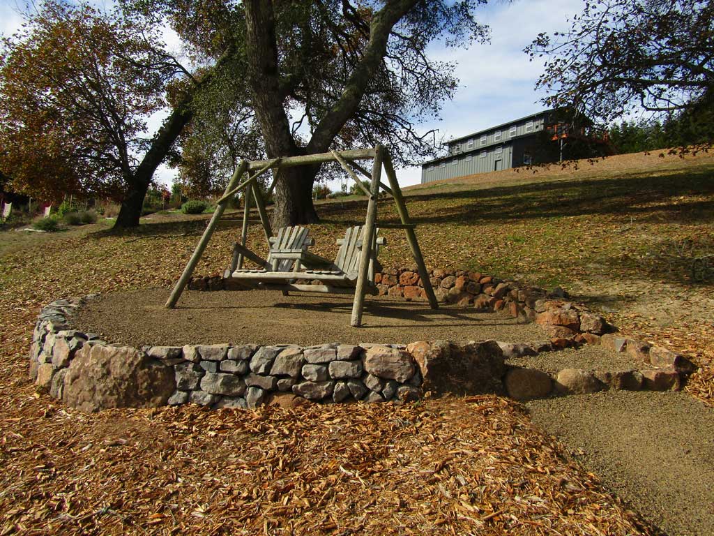 Gravel bench terrace cut into a garden slope