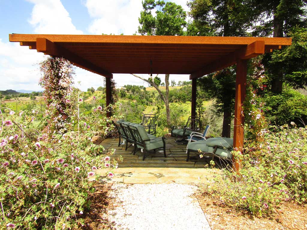 Steel pergola and refined plantings on a managed estate landscape in the Sonoma Valley